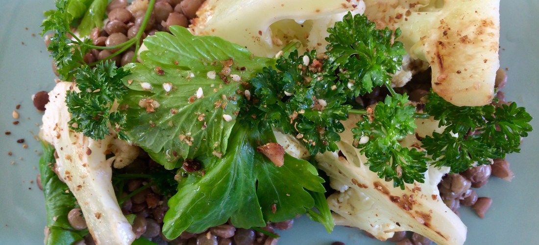 Blackened cauliflower salad with green lentils, clergy leaf, parsley and dairy-free yoghurt.